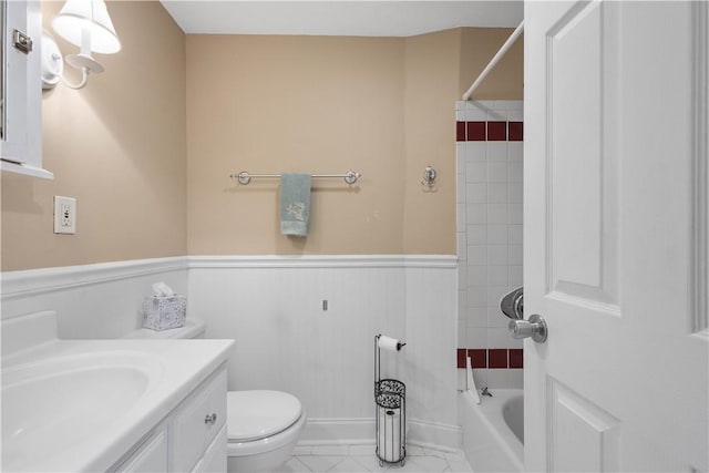 1064 Glen Oak Dr, Bethel Park, PA 15102 - full bath with vanity, toilet, wainscoting, tile patterned flooring, and tub / shower combination