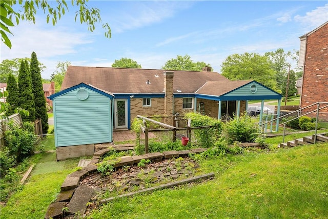 1064 Glen Oak Dr, Bethel Park, PA 15102 - back of property featuring a vegetable garden and a chimney