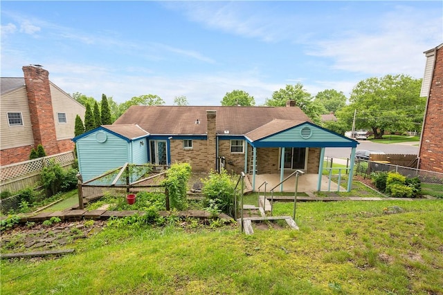 1064 Glen Oak Dr, Bethel Park, PA 15102 - rear view of house with a patio area, a fenced backyard, brick siding, and a storage shed