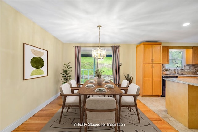 1064 Glen Oak Dr, Bethel Park, PA 15102 - dining room with a chandelier, light wood-style floors, and baseboards