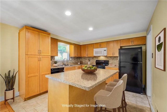1064 Glen Oak Dr, Bethel Park, PA 15102 - kitchen with black appliances, tasteful backsplash, a kitchen island, a sink, and a kitchen breakfast bar