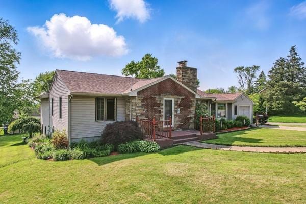 260 S Oakdale Ave, Hermitage, PA 16148 - view of front of home with a chimney, a front yard, and a garage