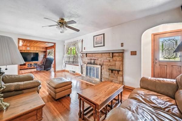 260 S Oakdale Ave, Hermitage, PA 16148 - living room featuring a ceiling fan, a fireplace, wood finished floors, and arched walkways