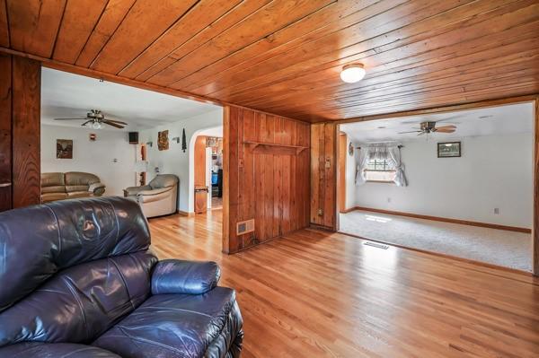 260 S Oakdale Ave, Hermitage, PA 16148 - living room featuring ceiling fan, wood ceiling, light wood-style floors, wooden walls, and baseboards