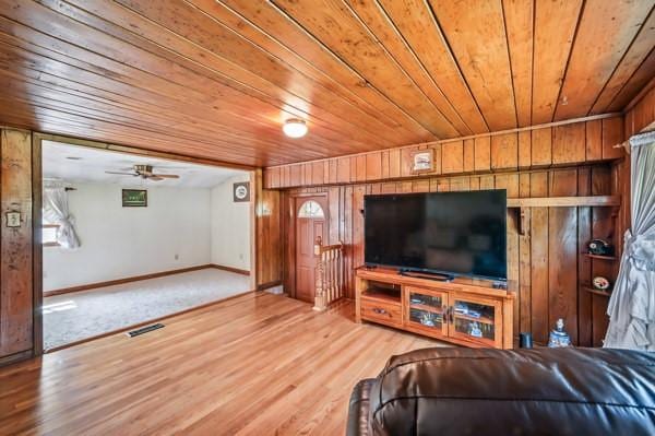 260 S Oakdale Ave, Hermitage, PA 16148 - living room featuring wood ceiling, wooden walls, wood finished floors, baseboards, and ceiling fan