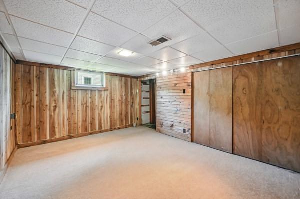 260 S Oakdale Ave, Hermitage, PA 16148 - basement featuring a paneled ceiling, wooden walls, and carpet