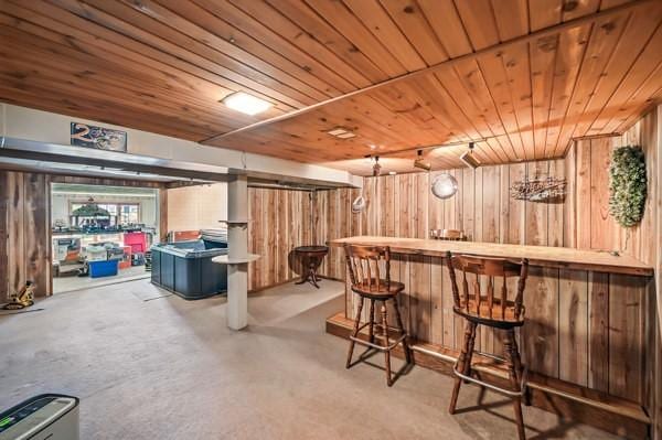 260 S Oakdale Ave, Hermitage, PA 16148 - indoor dry bar featuring wood walls, wood ceiling, and concrete flooring