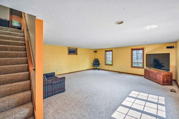 260 S Oakdale Ave, Hermitage, PA 16148 - unfurnished living room featuring carpet, baseboards, and stairs