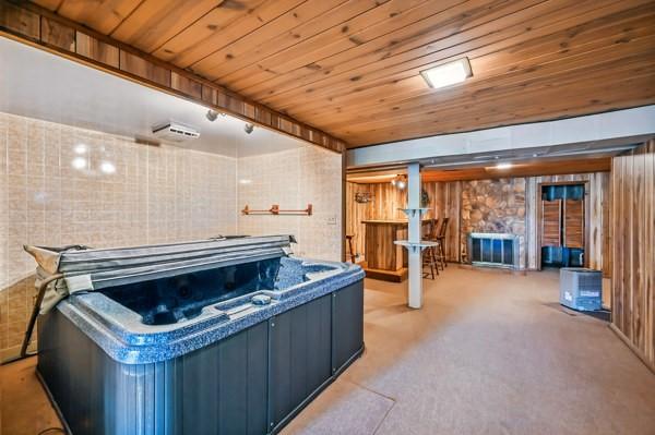 260 S Oakdale Ave, Hermitage, PA 16148 - miscellaneous room featuring carpet floors, a fireplace, wooden ceiling, and a jacuzzi