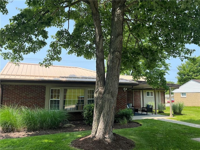 2617 S Hermitage Rd, Hermitage, PA 16148 - view of front of house with brick siding, a front yard, metal roof, and a patio area