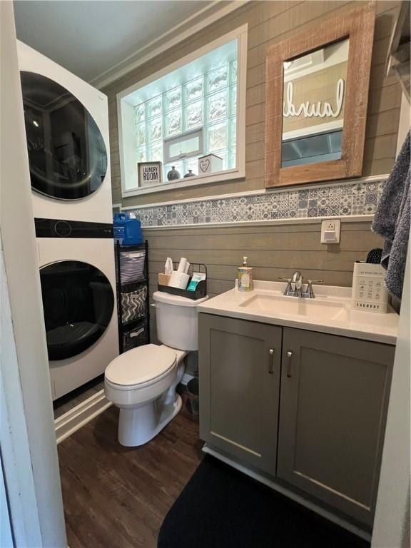 2617 S Hermitage Rd, Hermitage, PA 16148 - bathroom with stacked washer and clothes dryer, vanity, toilet, and wood finished floors