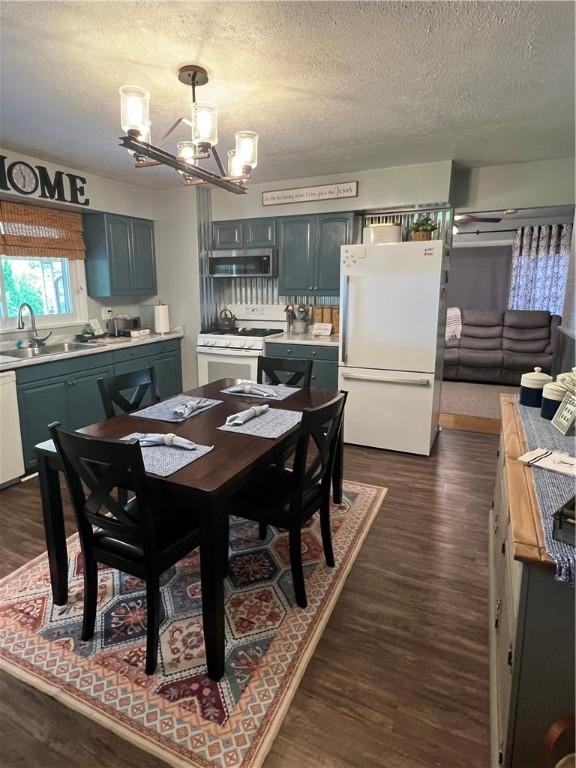 2617 S Hermitage Rd, Hermitage, PA 16148 - dining space featuring a chandelier, a textured ceiling, and dark wood-style flooring