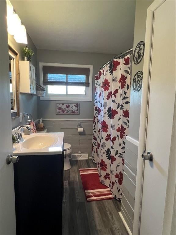 2617 S Hermitage Rd, Hermitage, PA 16148 - full bathroom with wood finished floors, vanity, toilet, a shower with curtain, and wainscoting
