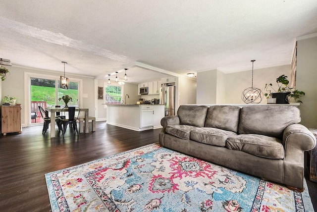 504 Diablo Dr, Bethel Park, PA 15102 - living room featuring a chandelier, dark wood-style flooring, a textured ceiling, baseboards, and ornamental molding