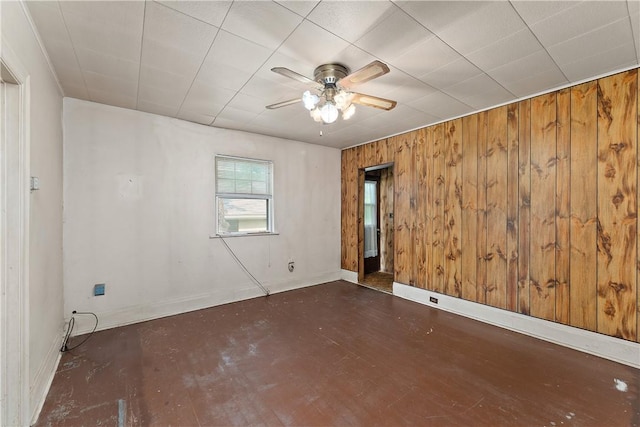 104 W Rd, Shaler, PA 15209 - empty room with a ceiling fan, wooden walls, baseboards, and wood finished floors