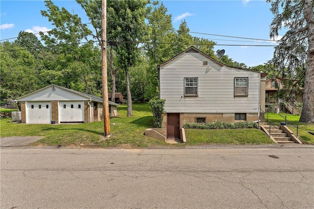 104 W Rd, Shaler, PA 15209 - view of home's exterior featuring a detached garage, a lawn, an outbuilding, and stairs
