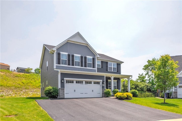 121 Derby Ln, North Fayette, PA 15071 - view of front of home featuring asphalt driveway, a garage, board and batten siding, and stone siding