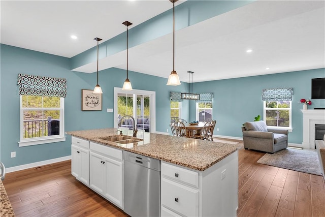 121 Derby Ln, North Fayette, PA 15071 - kitchen with stainless steel dishwasher, a sink, wood-type flooring, light stone counters, and recessed lighting