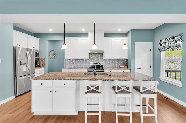 121 Derby Ln, North Fayette, PA 15071 - kitchen with stainless steel appliances, a sink, light wood-style flooring, baseboards, and backsplash
