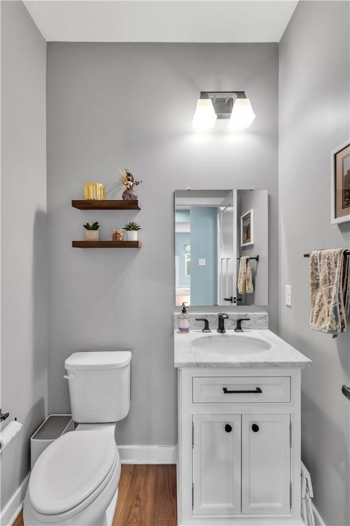 121 Derby Ln, North Fayette, PA 15071 - bathroom with toilet, vanity, wood finished floors, and baseboards