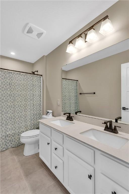 121 Derby Ln, North Fayette, PA 15071 - full bathroom featuring double vanity, toilet, tile patterned floors, and a shower with curtain