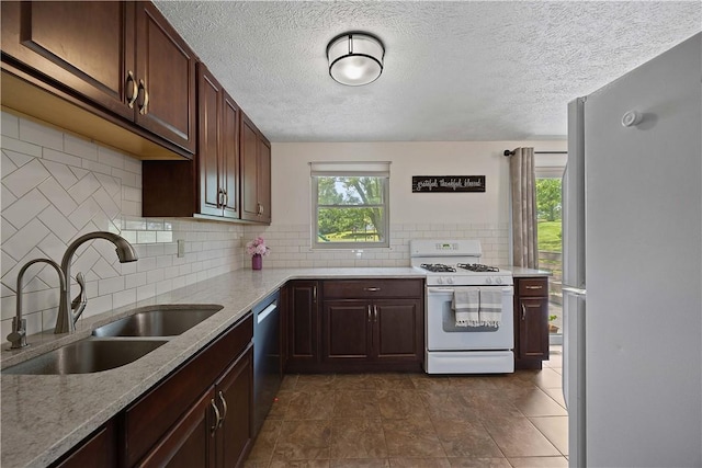 119 Summit Ridge Dr, Bridgeville, PA 15017 - kitchen with white appliances, a sink, decorative backsplash, a textured ceiling, and light stone counters
