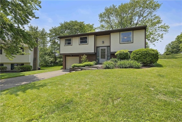 119 Summit Ridge Dr, Bridgeville, PA 15017 - bi-level home with concrete driveway, an attached garage, a front lawn, and brick siding