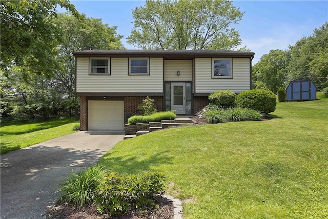 119 Summit Ridge Dr, Bridgeville, PA 15017 - raised ranch featuring asphalt driveway, brick siding, a front lawn, and a garage