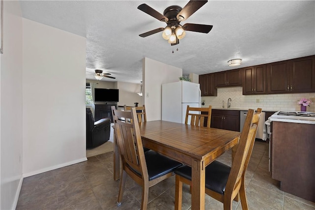 119 Summit Ridge Dr, Bridgeville, PA 15017 - tiled dining space featuring ceiling fan, a sink, baseboards, and a textured ceiling