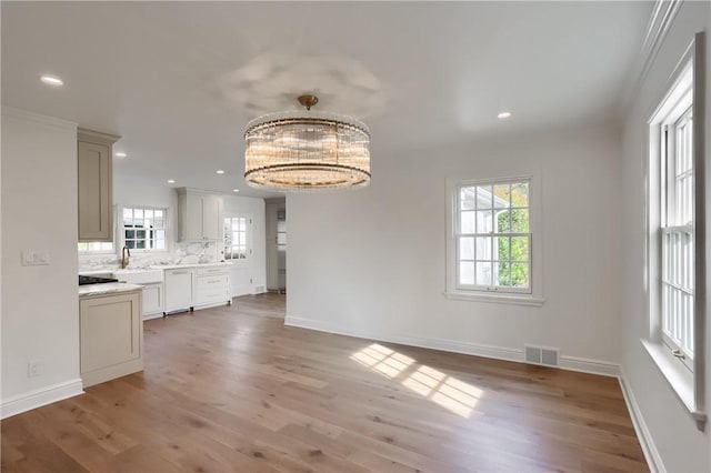 129 S Dr, Fox Chapel, PA 15238 - unfurnished dining area with plenty of natural light, light wood finished floors, baseboards, a chandelier, and recessed lighting