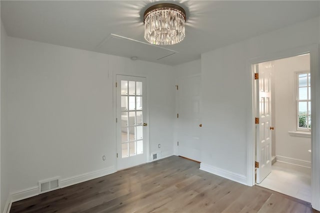 129 S Dr, Fox Chapel, PA 15238 - spare room featuring wood finished floors, a chandelier, and baseboards