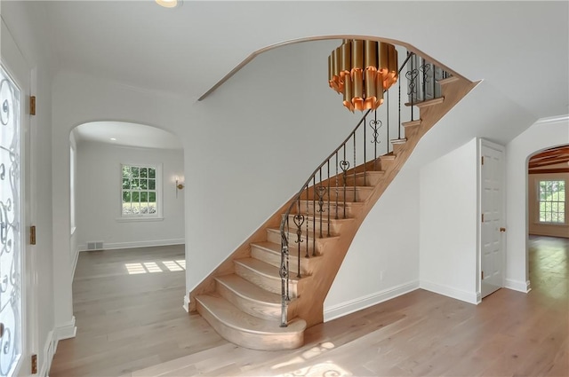 129 S Dr, Fox Chapel, PA 15238 - entryway featuring arched walkways, wood finished floors, stairway, and baseboards