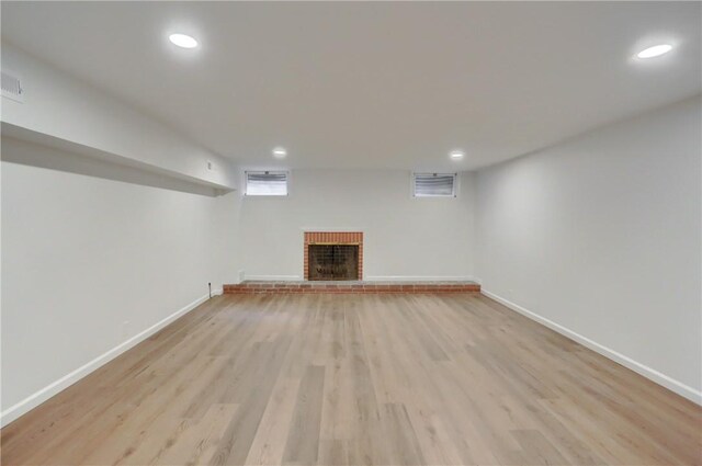 129 S Dr, Fox Chapel, PA 15238 - below grade area with recessed lighting, baseboards, a brick fireplace, and light wood-type flooring