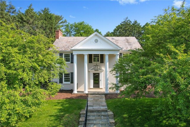 129 S Dr, Fox Chapel, PA 15238 - greek revival inspired property with a front yard, a chimney, stucco siding, and a porch