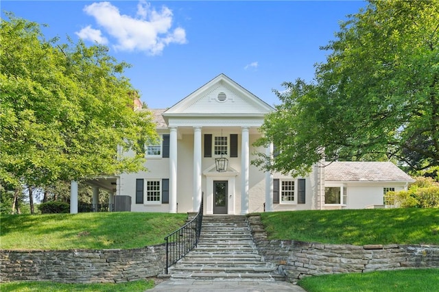 129 S Dr, Fox Chapel, PA 15238 - neoclassical / greek revival house with a front yard, stucco siding, and central AC unit