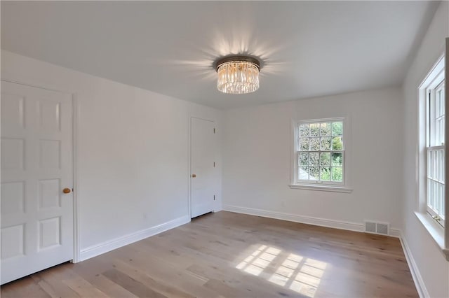 129 S Dr, Fox Chapel, PA 15238 - unfurnished room with a chandelier, wood finished floors, and baseboards