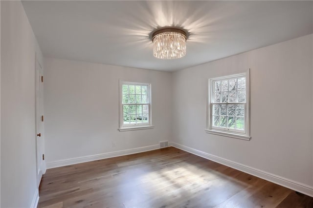 129 S Dr, Fox Chapel, PA 15238 - empty room with a chandelier, wood finished floors, and baseboards