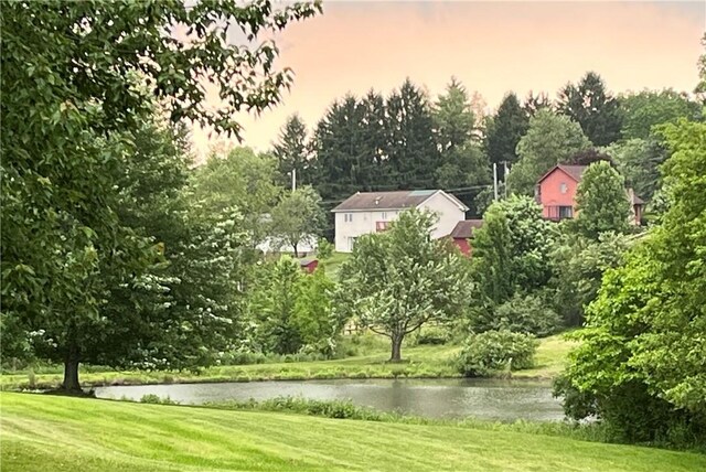 138 Willow Run Dr, Center Twp But, PA 16001 - yard at dusk with a water view, a lawn, and view of scattered trees