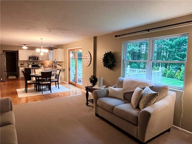 138 Willow Run Dr, Center Twp But, PA 16001 - living area with light wood-style floors, a chandelier, and baseboards
