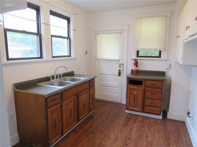 1111 Progress St, Mckees Rocks, PA 15136 - kitchen featuring a sink, dark wood finished floors, dark countertops, and brown cabinetry
