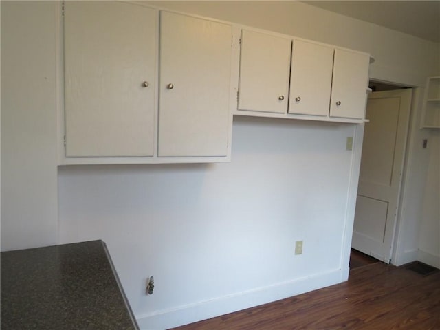 1111 Progress St, Mckees Rocks, PA 15136 - kitchen with dark wood-style flooring, baseboards, and white cabinets