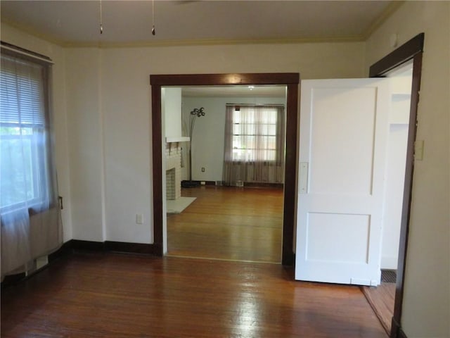 1111 Progress St, Mckees Rocks, PA 15136 - spare room with crown molding, wood finished floors, a brick fireplace, and baseboards