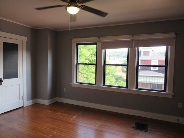1111 Progress St, Mckees Rocks, PA 15136 - spare room featuring baseboards, dark wood finished floors, a ceiling fan, and crown molding