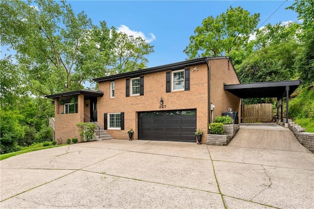 227 Shady Knoll Dr, Scott Twp Sal, PA 15220 - split level home featuring a garage, brick siding, and concrete driveway