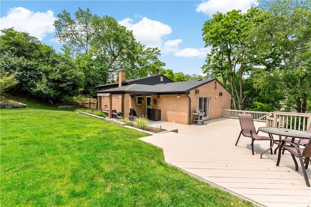 227 Shady Knoll Dr, Scott Twp Sal, PA 15220 - rear view of house featuring brick siding, a wooden deck, a yard, and a chimney