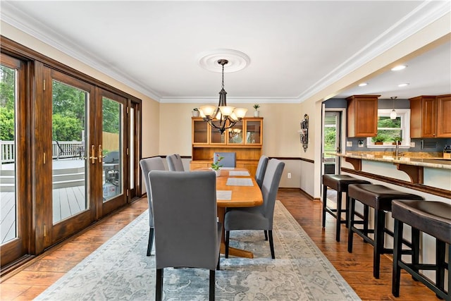 227 Shady Knoll Dr, Scott Twp Sal, PA 15220 - dining space featuring a chandelier, plenty of natural light, ornamental molding, baseboards, and wood finished floors