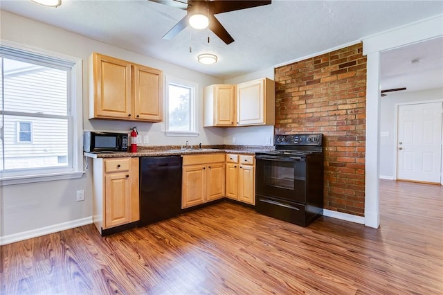 149-151 French St, Hempfield Twp Wml, PA 15601 - kitchen with black appliances, light brown cabinetry, a ceiling fan, wood finished floors, and baseboards
