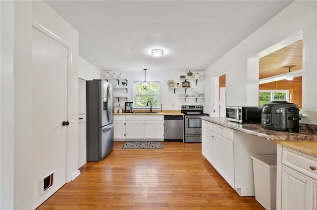 3702 School Rd, Murrysville, PA 15668 - kitchen featuring stainless steel appliances, a sink, open shelves, and plenty of natural light