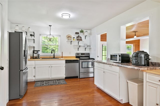 3702 School Rd, Murrysville, PA 15668 - kitchen featuring stainless steel appliances, open shelves, a sink, white cabinetry, and plenty of natural light