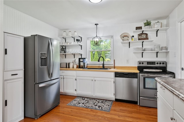 3702 School Rd, Murrysville, PA 15668 - kitchen with stainless steel appliances, open shelves, a sink, and white cabinetry